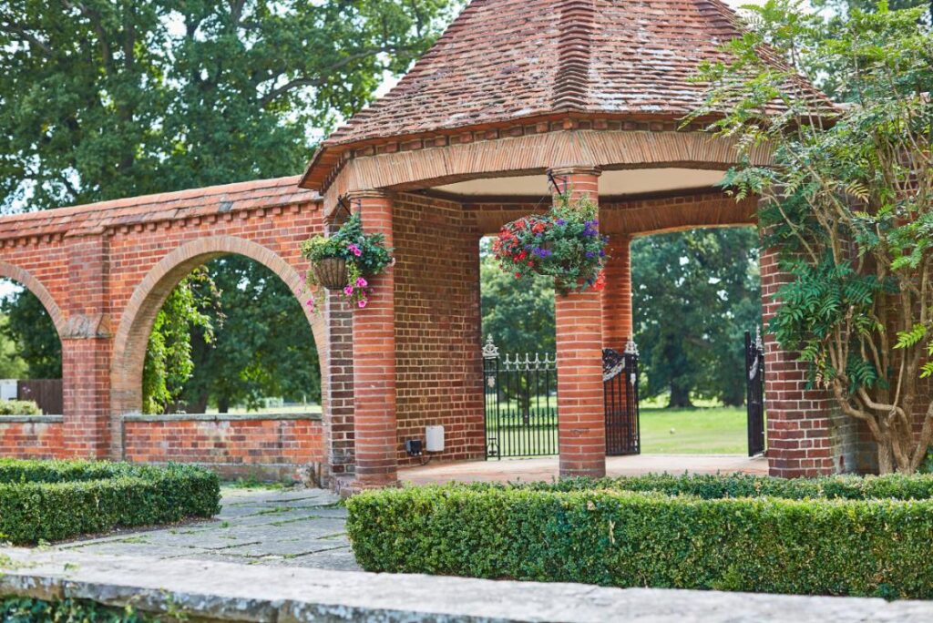 A beautiful brick pagoda surrounded by lush green scenery.