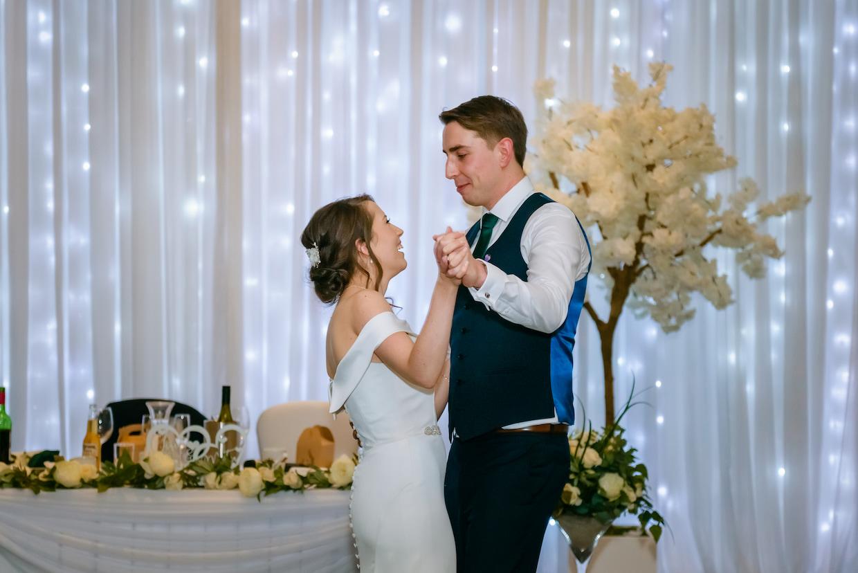 A bride and groom dancing together against a sparkling background, creating a magical and romantic atmosphere.